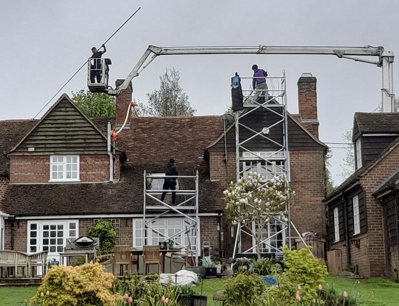The Moss Cleaners using cherry picker and scaffolding to clean roof safely and professionally in Tewkesbury, Gloucestershire